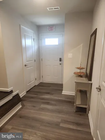 a view of an empty room and wooden floor