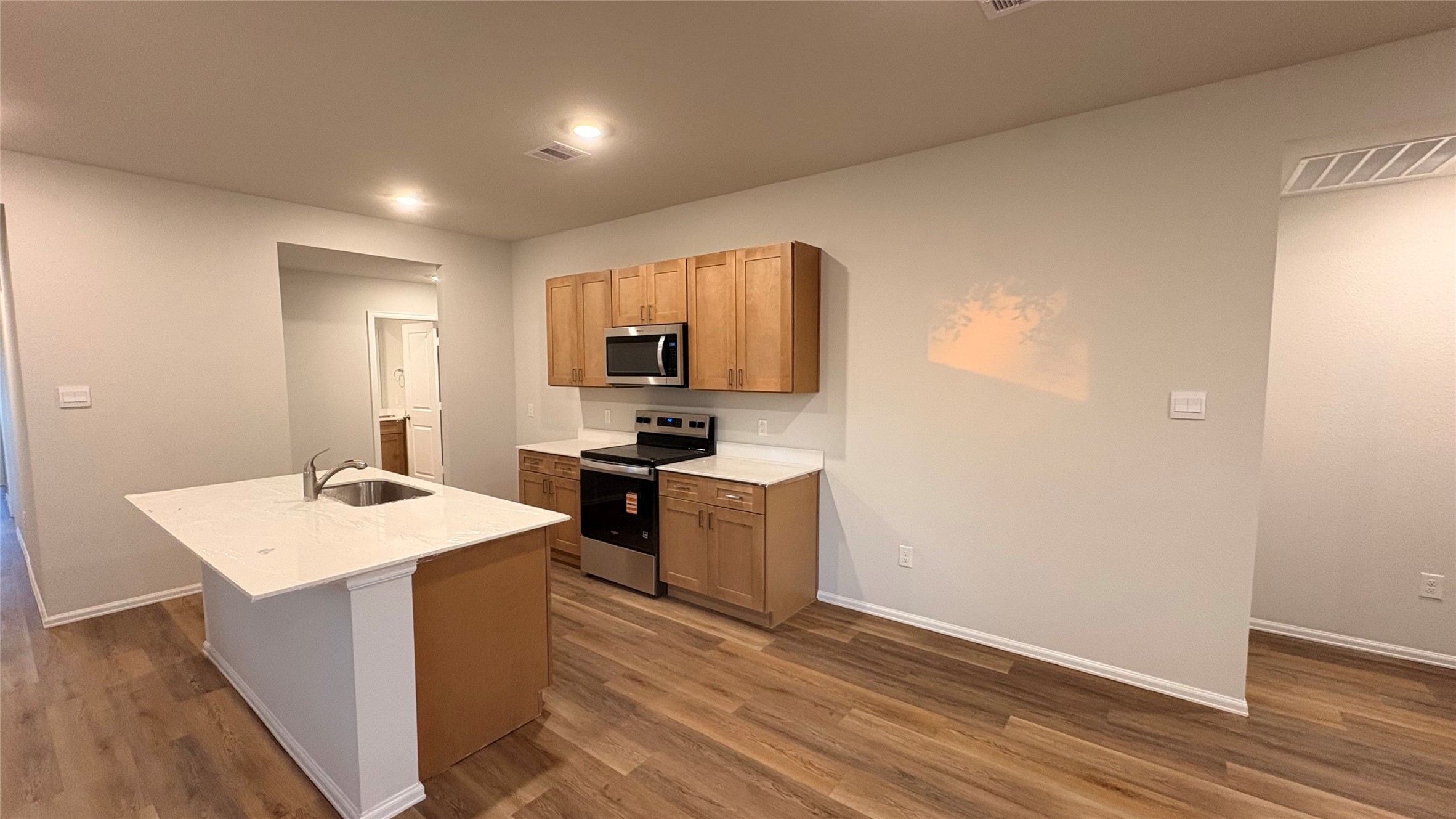 2306 White Wing Navasota, TX 77868 - Photo 4 of 6 a kitchen with a sink cabinets and wooden floor
