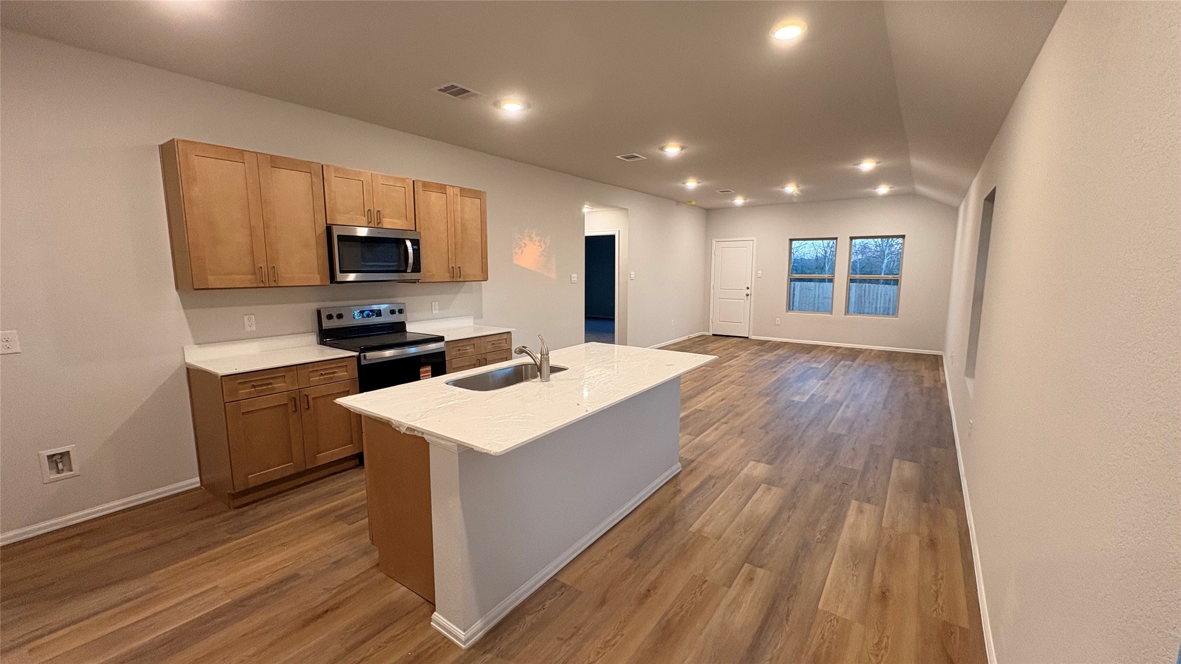 2306 White Wing Navasota, TX 77868 - Photo 5 of 6 a kitchen with a sink a microwave a stove and cabinets