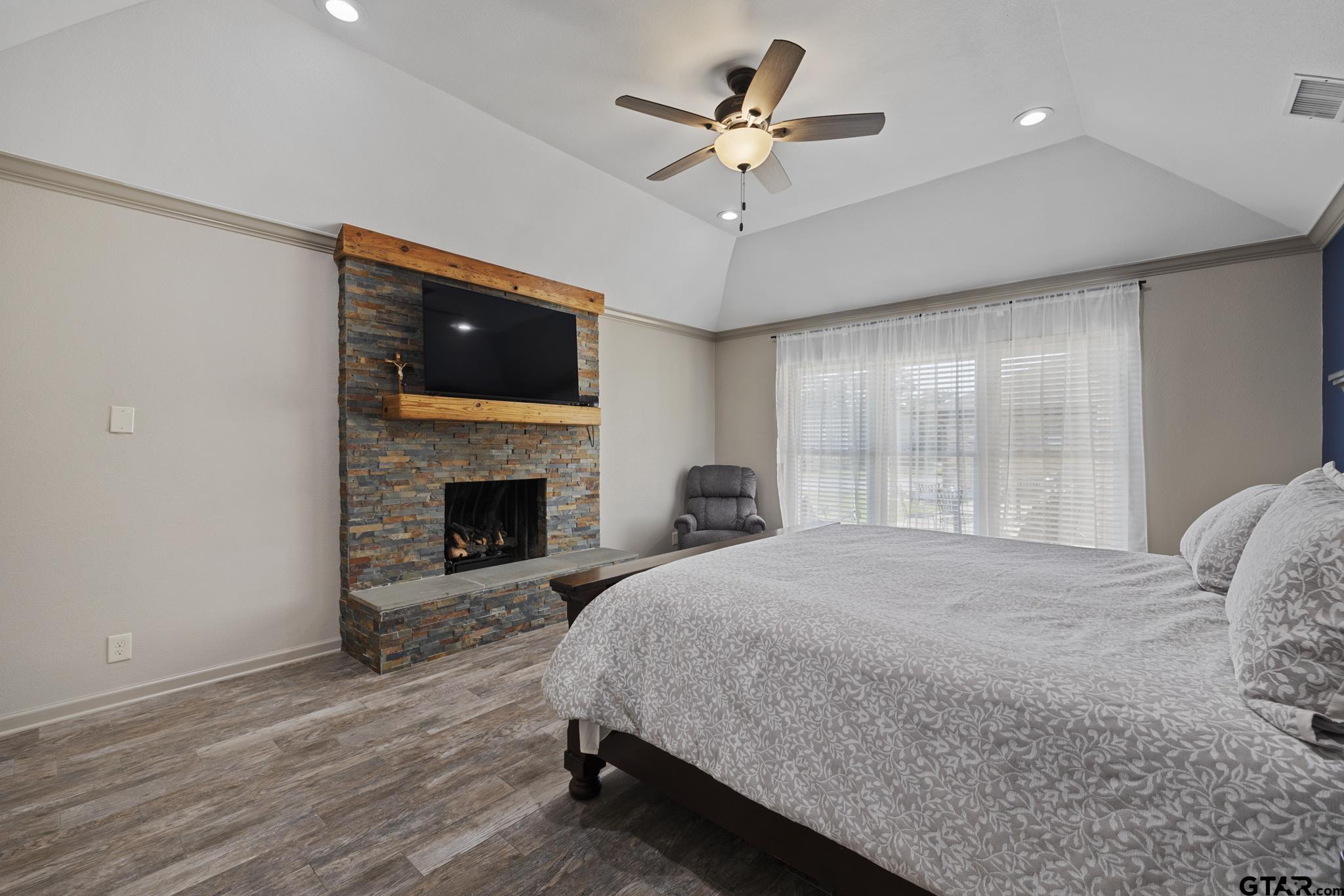 2201 Ridgley Tyler, TX 75703 - Photo 16 of 42 a spacious bedroom with a bed and a fireplace