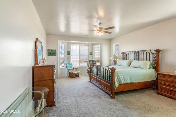 a spacious bedroom with a bed and furniture