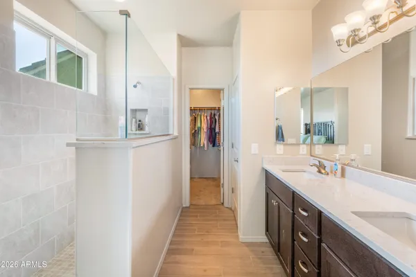 a bathroom with a double vanity sink and a mirror
