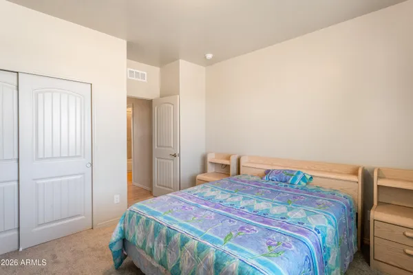 a bedroom with a bed and a closet