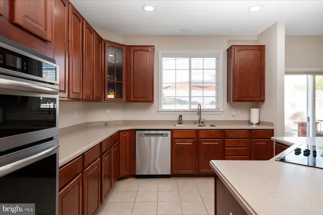 a kitchen with stainless steel appliances granite countertop a sink stove microwave and cabinets