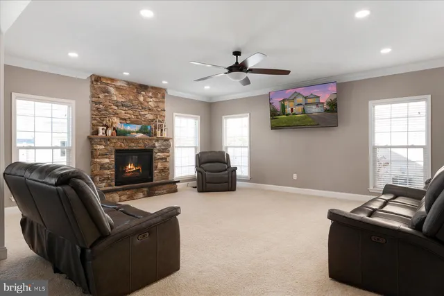 a living room with furniture a flat screen tv and a fireplace