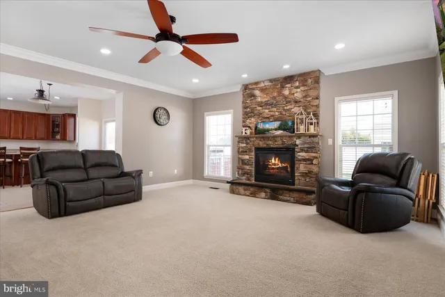 a living room with furniture a window and a fireplace