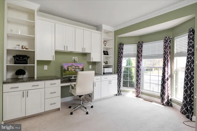 a view of workspace with wooden floor and windows