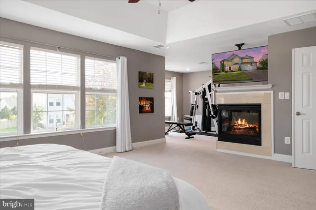 a view of a livingroom with a fireplace and large windows