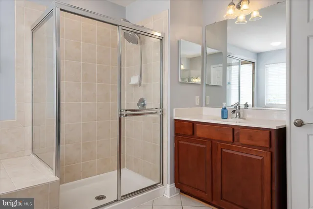 a bathroom with a shower sink and mirror
