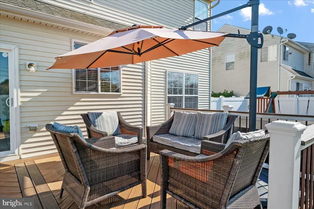 a view of a chair and tables in the balcony