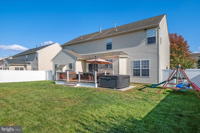 a view of a house with a yard and sitting area