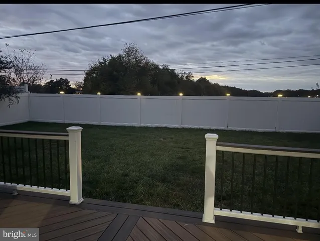 a roof deck with table and chairs