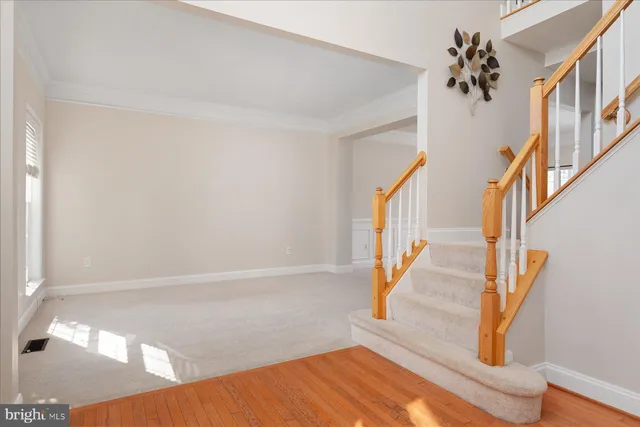 a view of staircase with white walls and a window