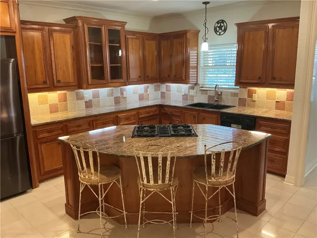 a kitchen with a table chairs cabinets and window