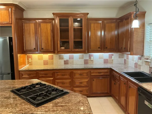 a kitchen with a sink stove and cabinets