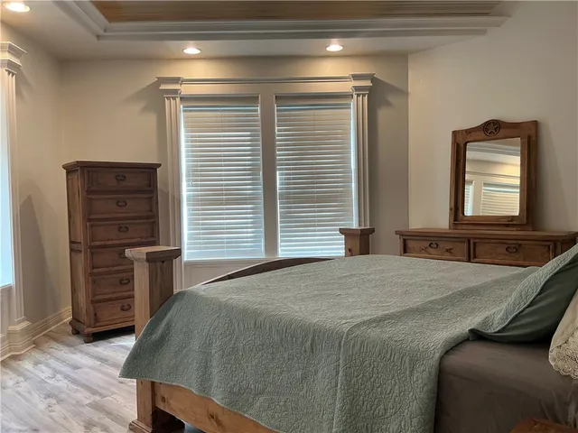 a bedroom with a bed and a television