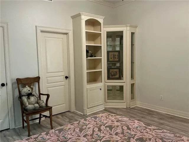 a view of livingroom with workspace and wooden floor