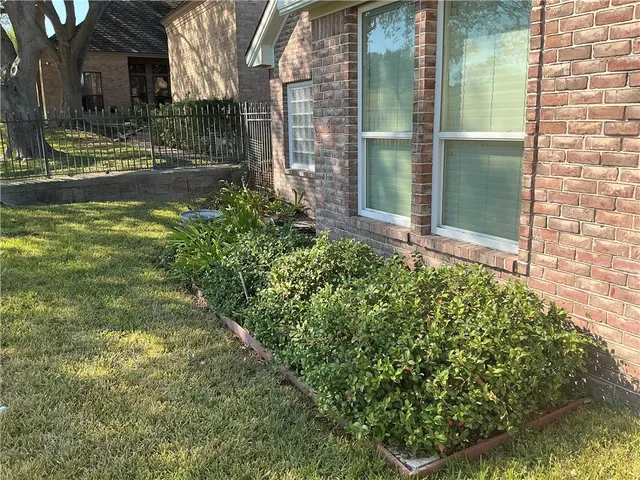 a view of yellow house with a yard