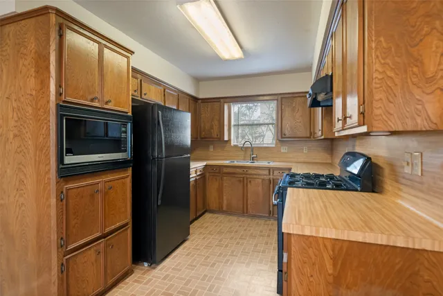 a view of a kitchen with a sink and a large window