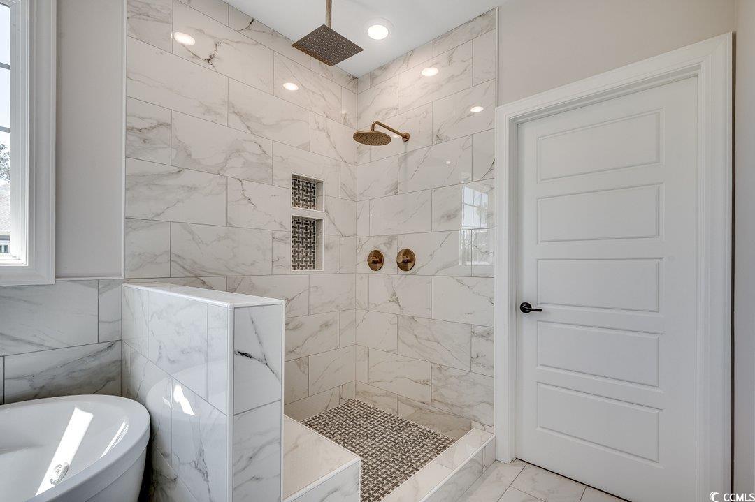 1007 Brood Court Conway, SC 29526 - Photo 19 of 40 Bathroom with a freestanding tub, marble finish floor, and a tile shower