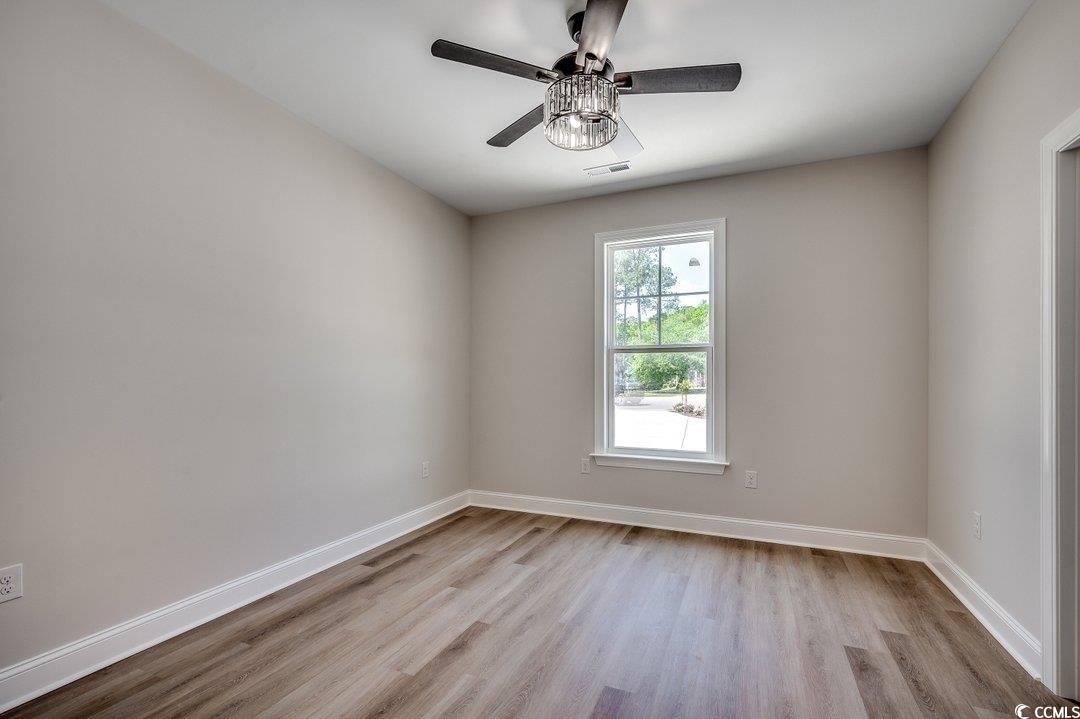 1007 Brood Court Conway, SC 29526 - Photo 22 of 40 Empty room with visible vents, baseboards, a ceiling fan, and wood finished floors