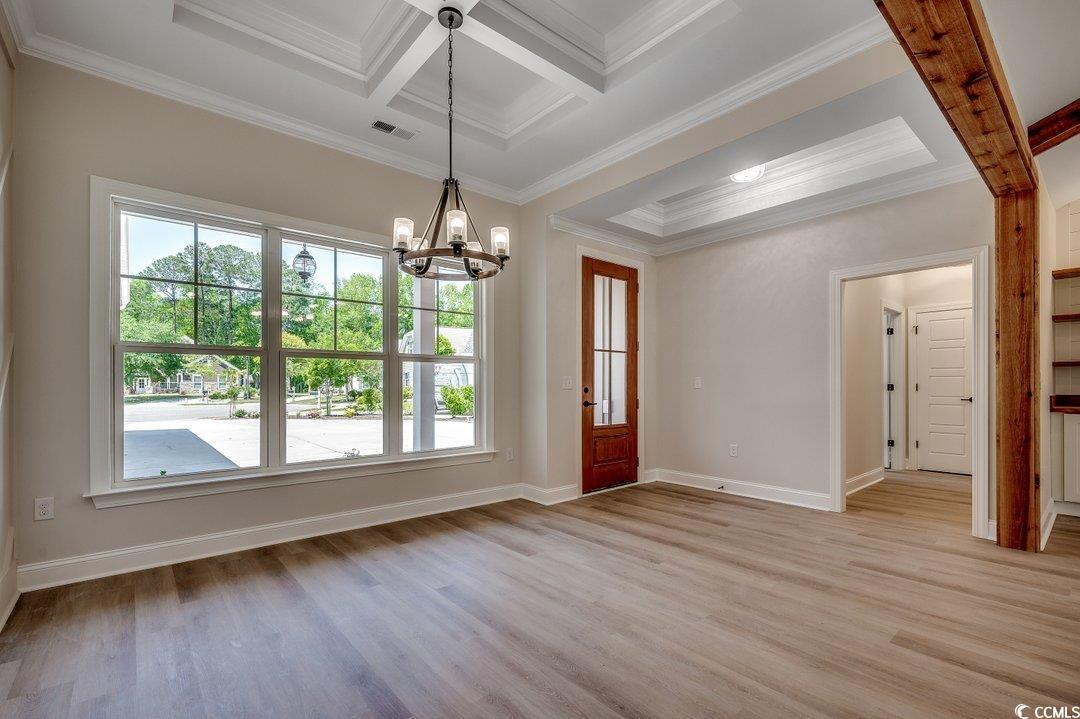 1007 Brood Court Conway, SC 29526 - Photo 6 of 40 Foyer entrance with a healthy amount of sunlight, ornamental molding, and an inviting chandelier