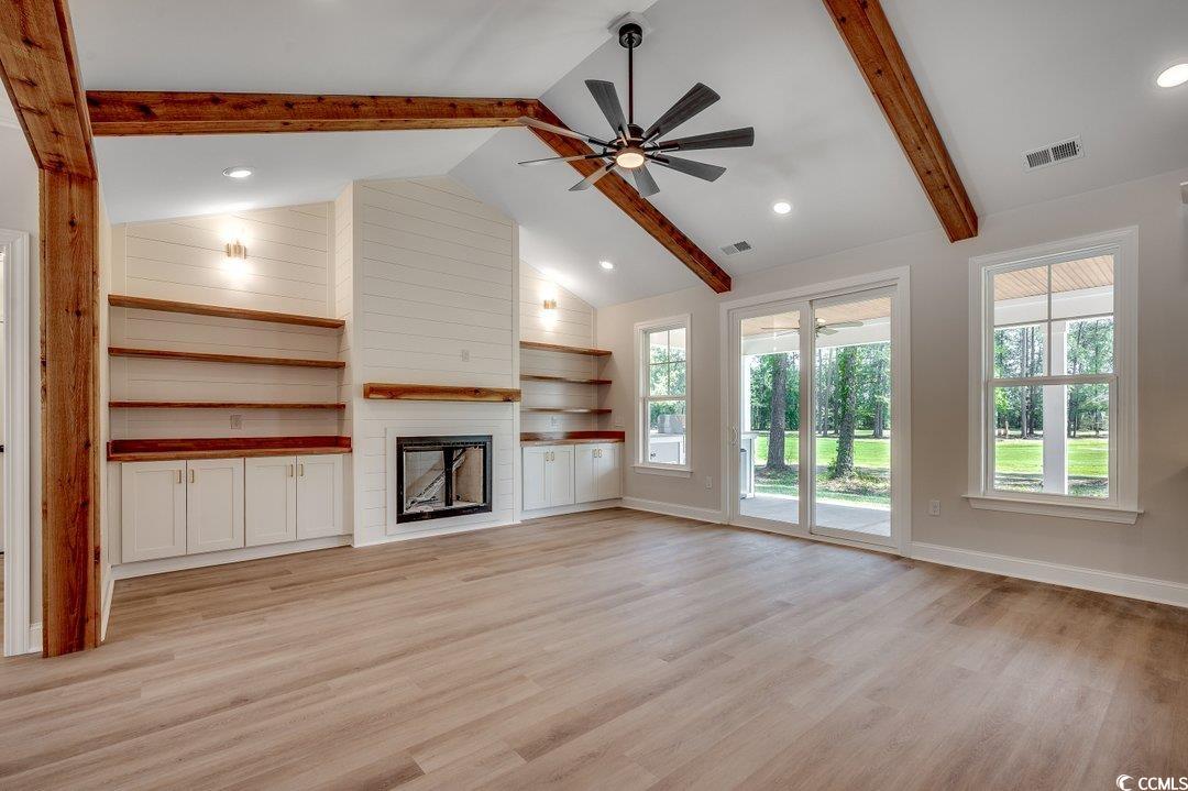 1007 Brood Court Conway, SC 29526 - Photo 7 of 40 Unfurnished living room with light wood finished floors, visible vents, beamed ceiling, a fireplace, and ceiling fan