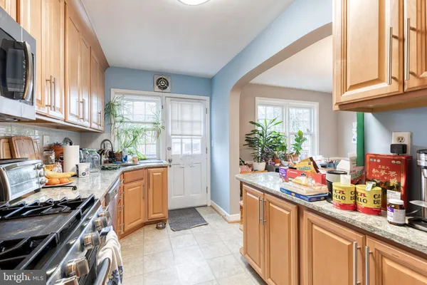 a kitchen filled with a white stove top oven sink and cabinets
