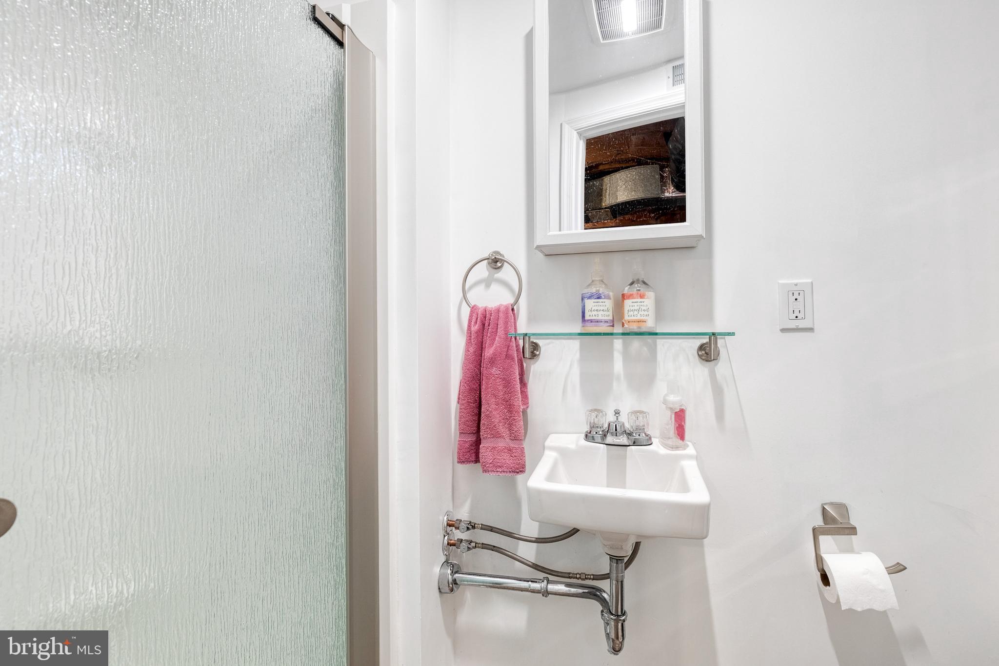 110 Regester Avenue Baltimore, MD 21212 - Photo 4 of 15 a bathroom with a sink and a mirror