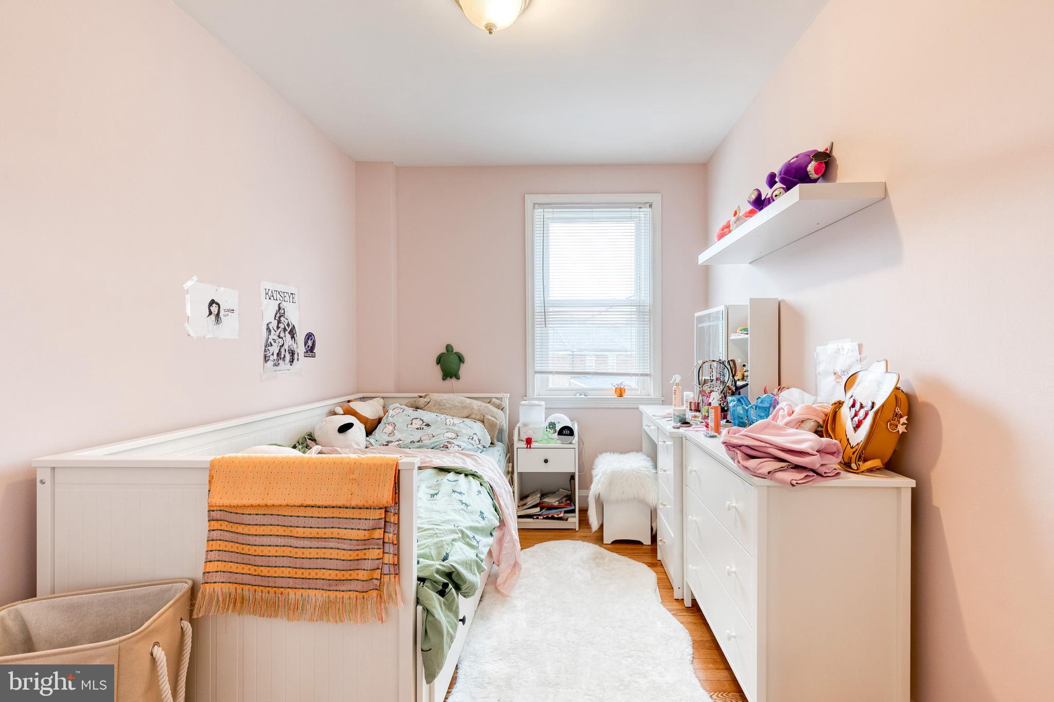 110 Regester Avenue Baltimore, MD 21212 - Photo 5 of 15 a bedroom with furniture and a window