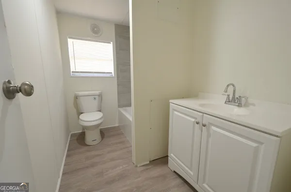 a bathroom with a sink toilet and vanity