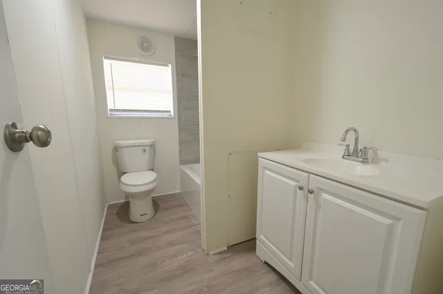 a bathroom with a sink toilet and vanity