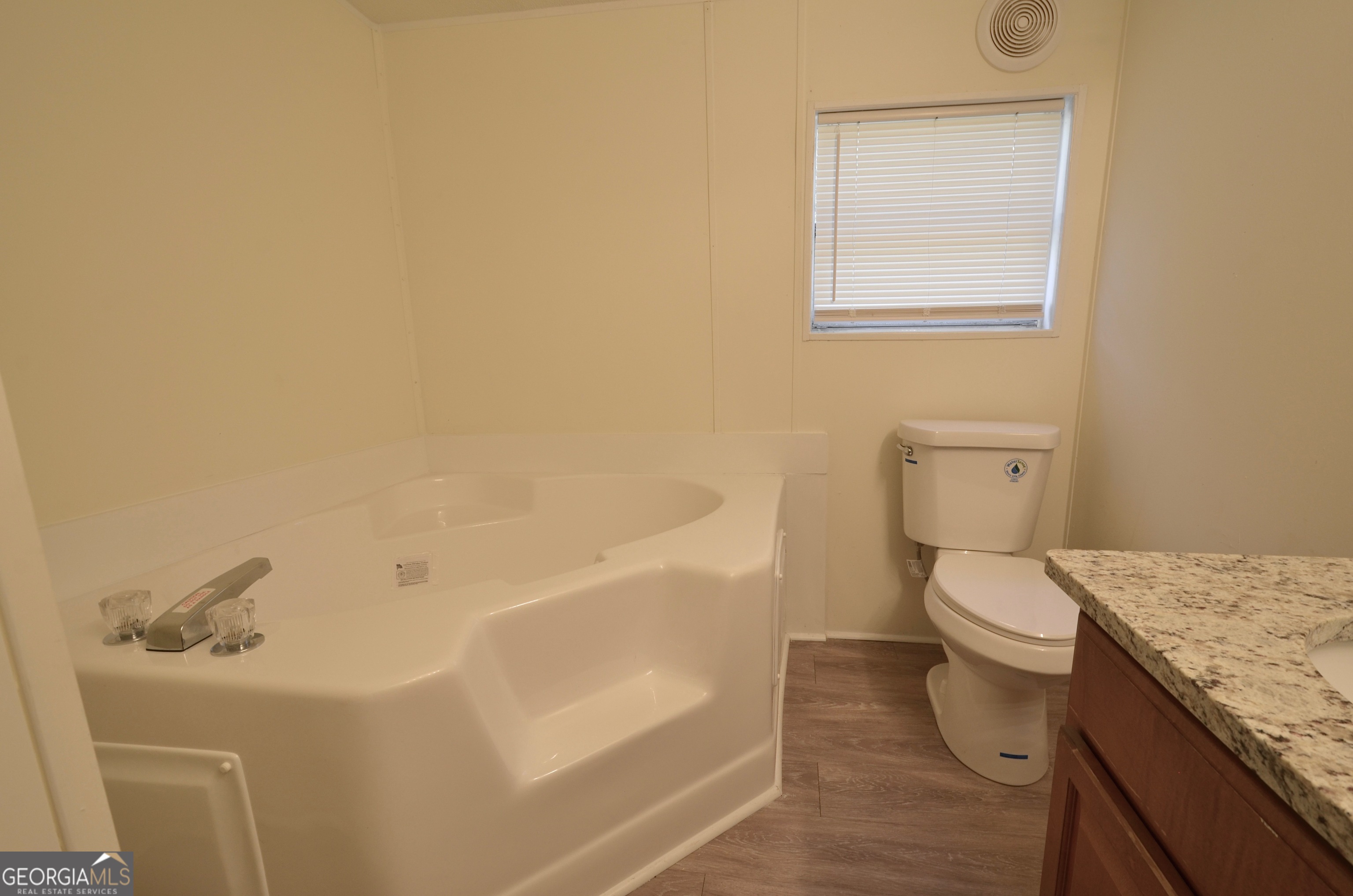 722 Brower Court Dublin, GA 31021 - Photo 13 of 27 a bath room with a toilet and a bath tub