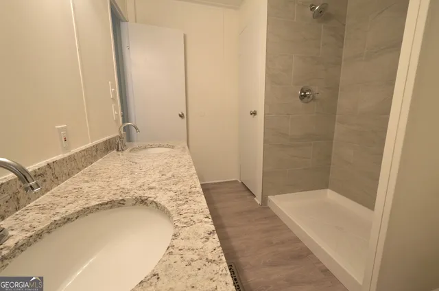 a bathroom with a bathtub and shower