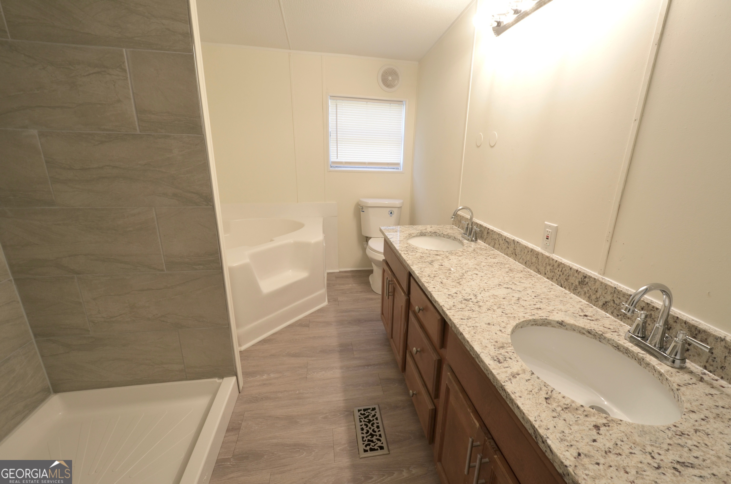 722 Brower Court Dublin, GA 31021 - Photo 17 of 27 a bathroom with a granite countertop tub sink and mirror