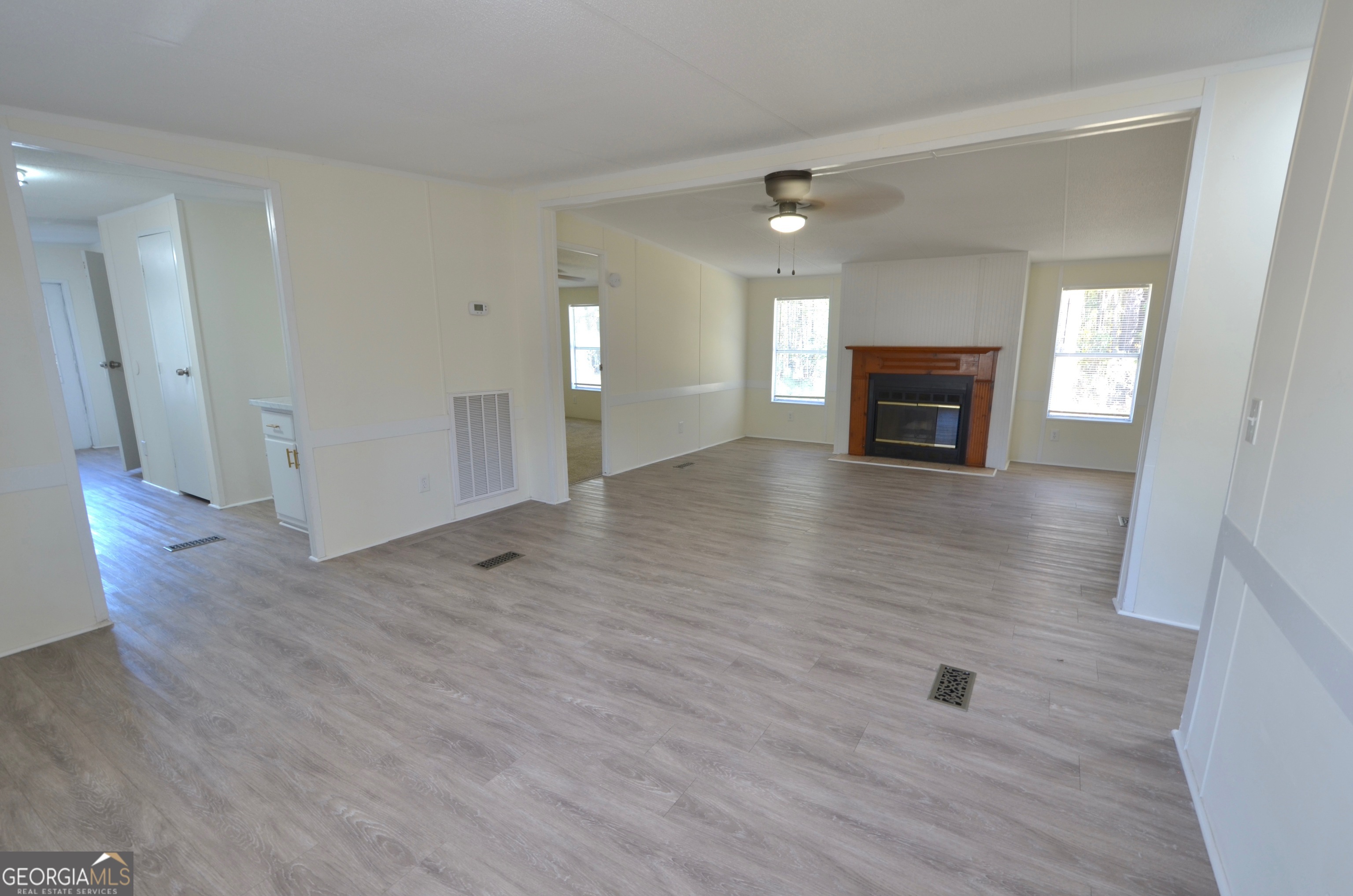 722 Brower Court Dublin, GA 31021 - Photo 18 of 27 a view of an empty room with wooden floor and a fireplace