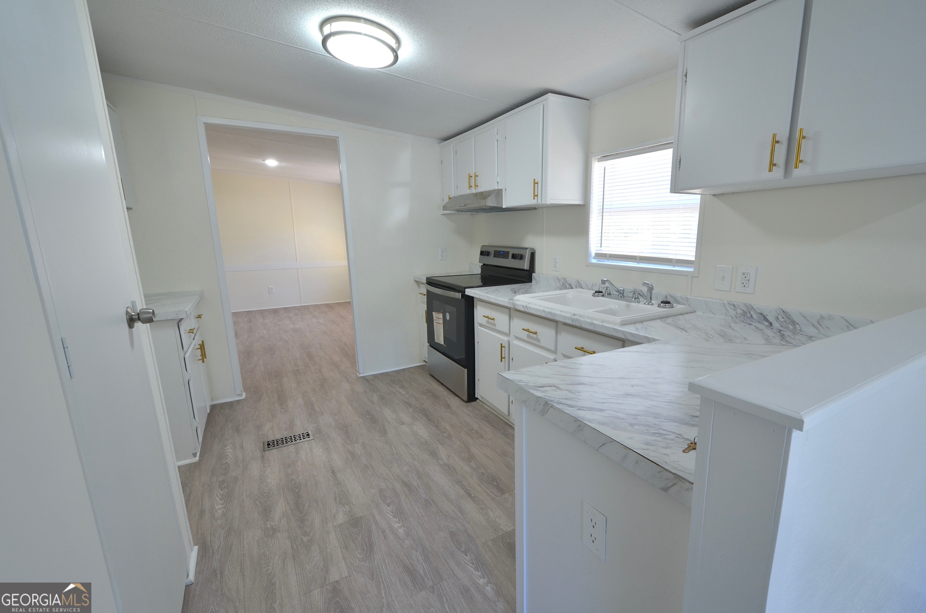 722 Brower Court Dublin, GA 31021 - Photo 4 of 27 a kitchen with a sink a stove a refrigerator and cabinets