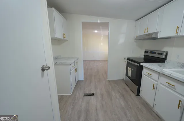 a view of a kitchen with electric appliances