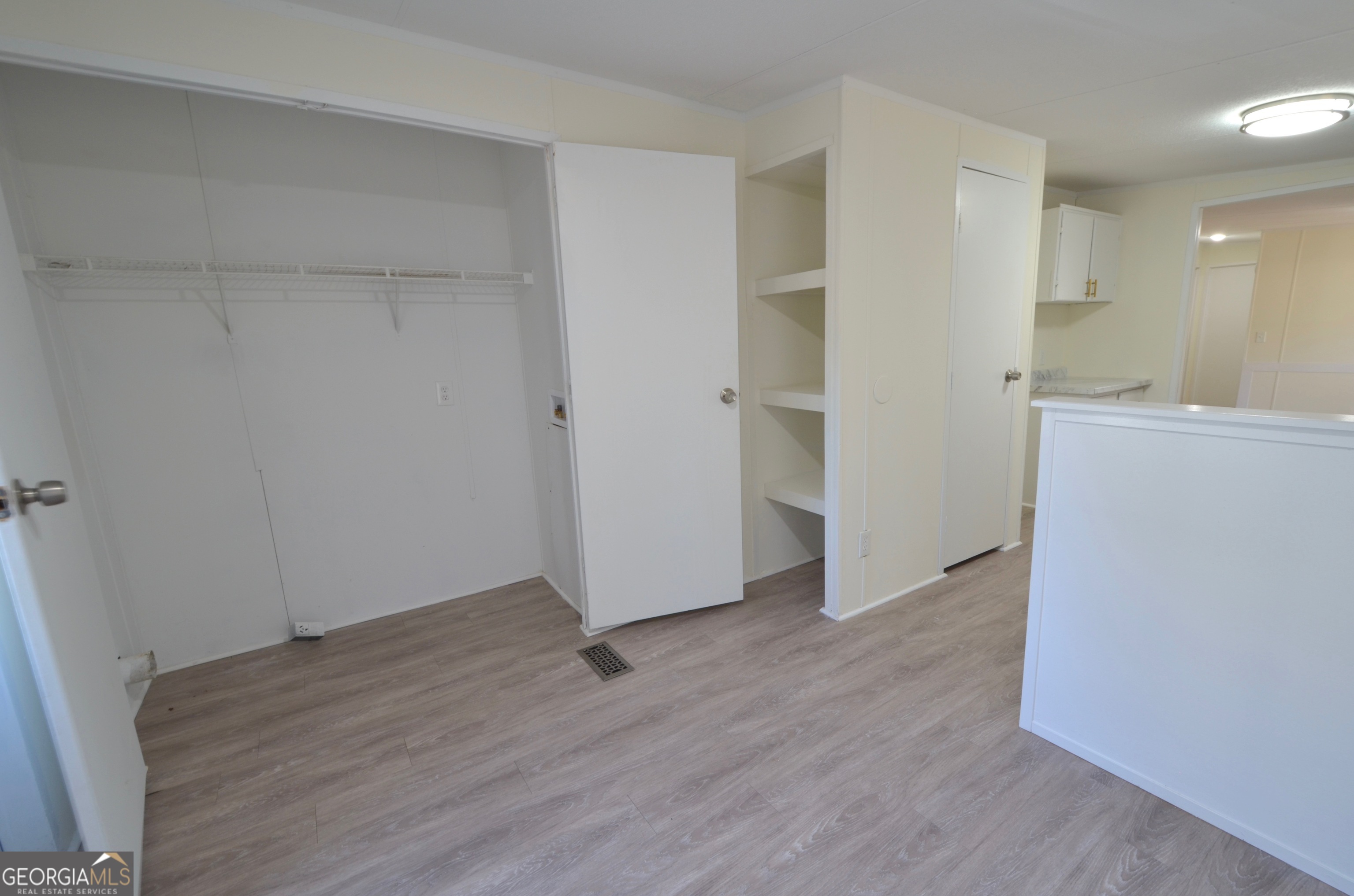 722 Brower Court Dublin, GA 31021 - Photo 10 of 27 wooden floor in an empty room with a window