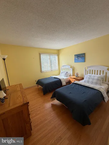 a bedroom with a bed and a night stand