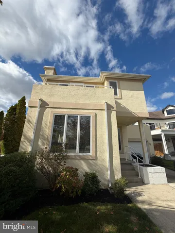 a view of a house with many windows and a yard