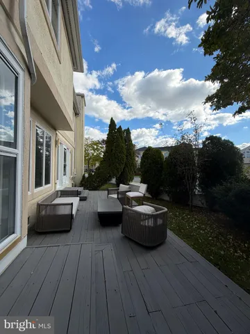 a view of a patio with couches and potted plants