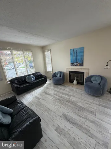 a living room with furniture a couch and dresser