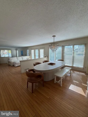 a living room with furniture a table and wooden floor