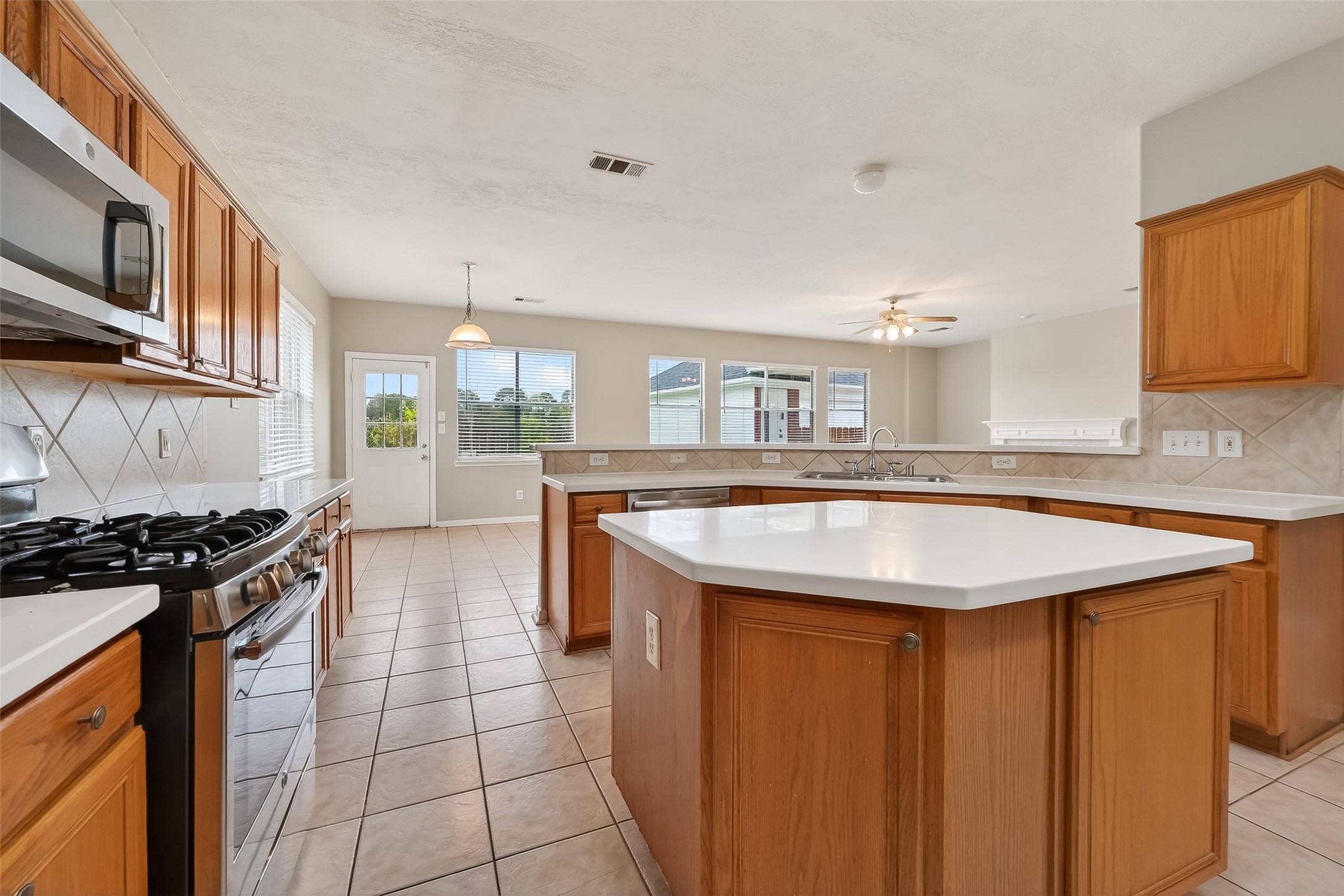 16639 Village View Trail Sugar Land, TX 77498 - Photo 14 of 50 a kitchen with stainless steel appliances granite countertop a sink and a stove