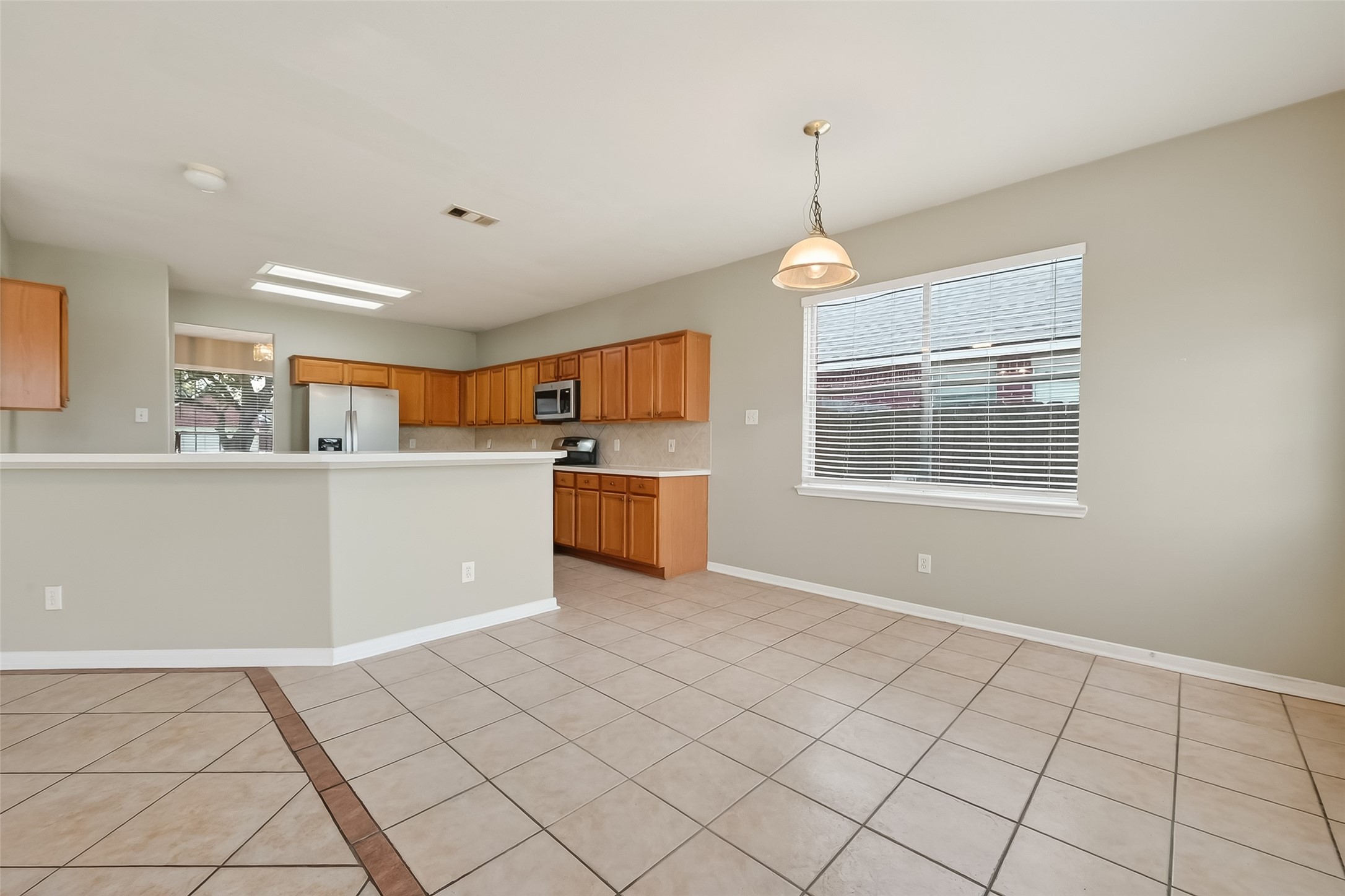 16639 Village View Trail Sugar Land, TX 77498 - Photo 19 of 50 a kitchen with stainless steel appliances granite countertop a stove top oven a sink dishwasher and a refrigerator with wooden floor