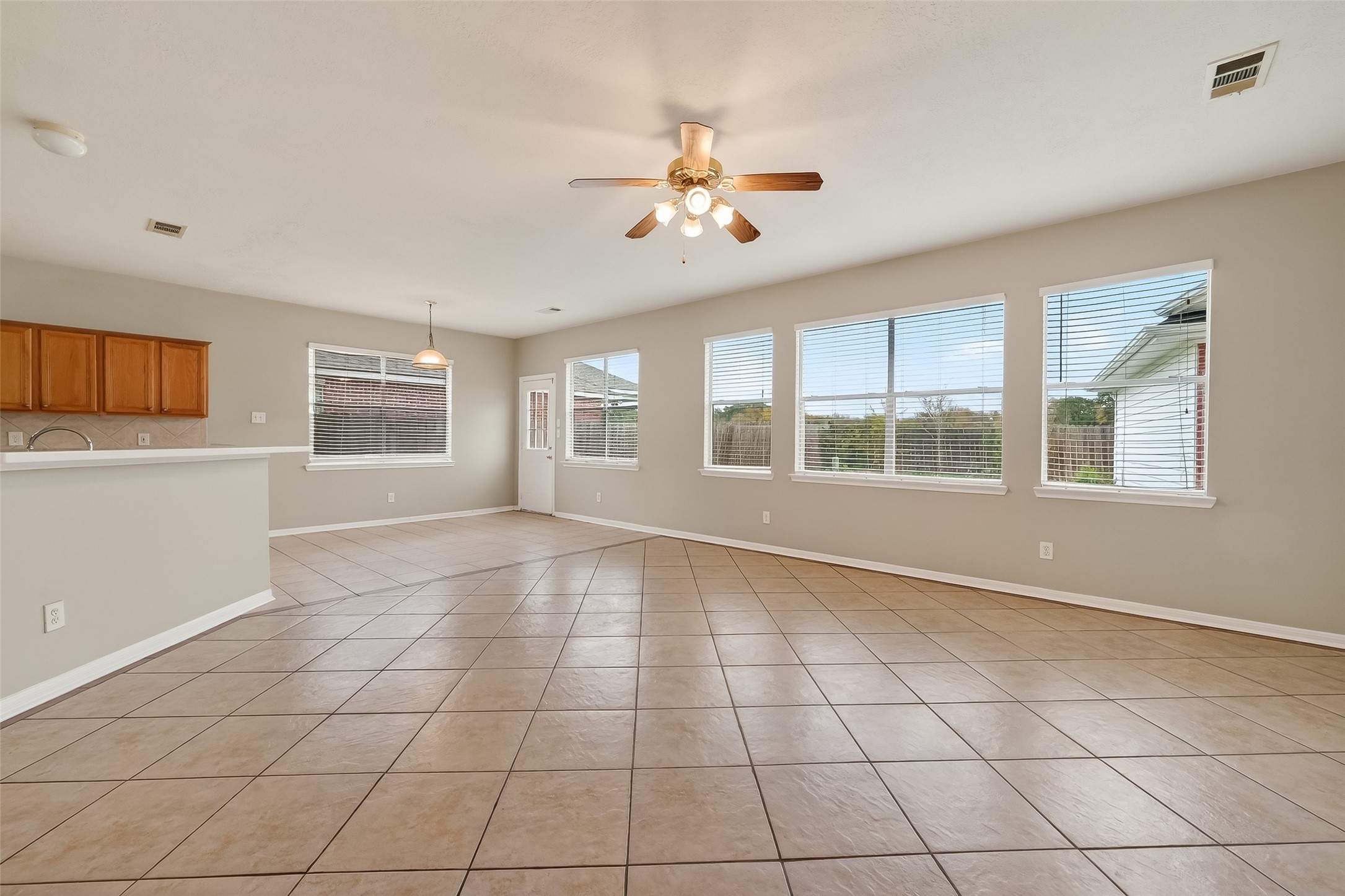 16639 Village View Trail Sugar Land, TX 77498 - Photo 22 of 50 a view of an empty room with a window and chandelier fan