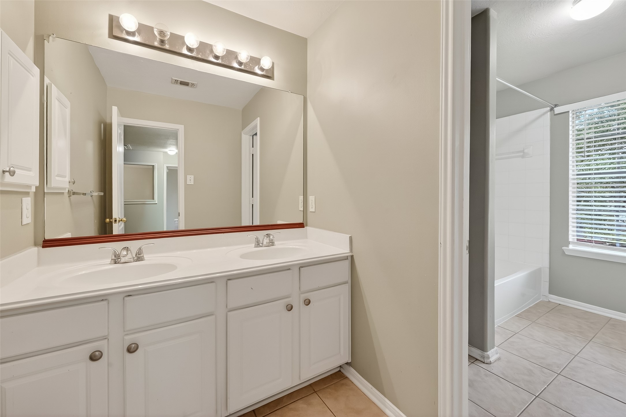 16639 Village View Trail Sugar Land, TX 77498 - Photo 31 of 50 a bathroom with a double vanity sink and a mirror