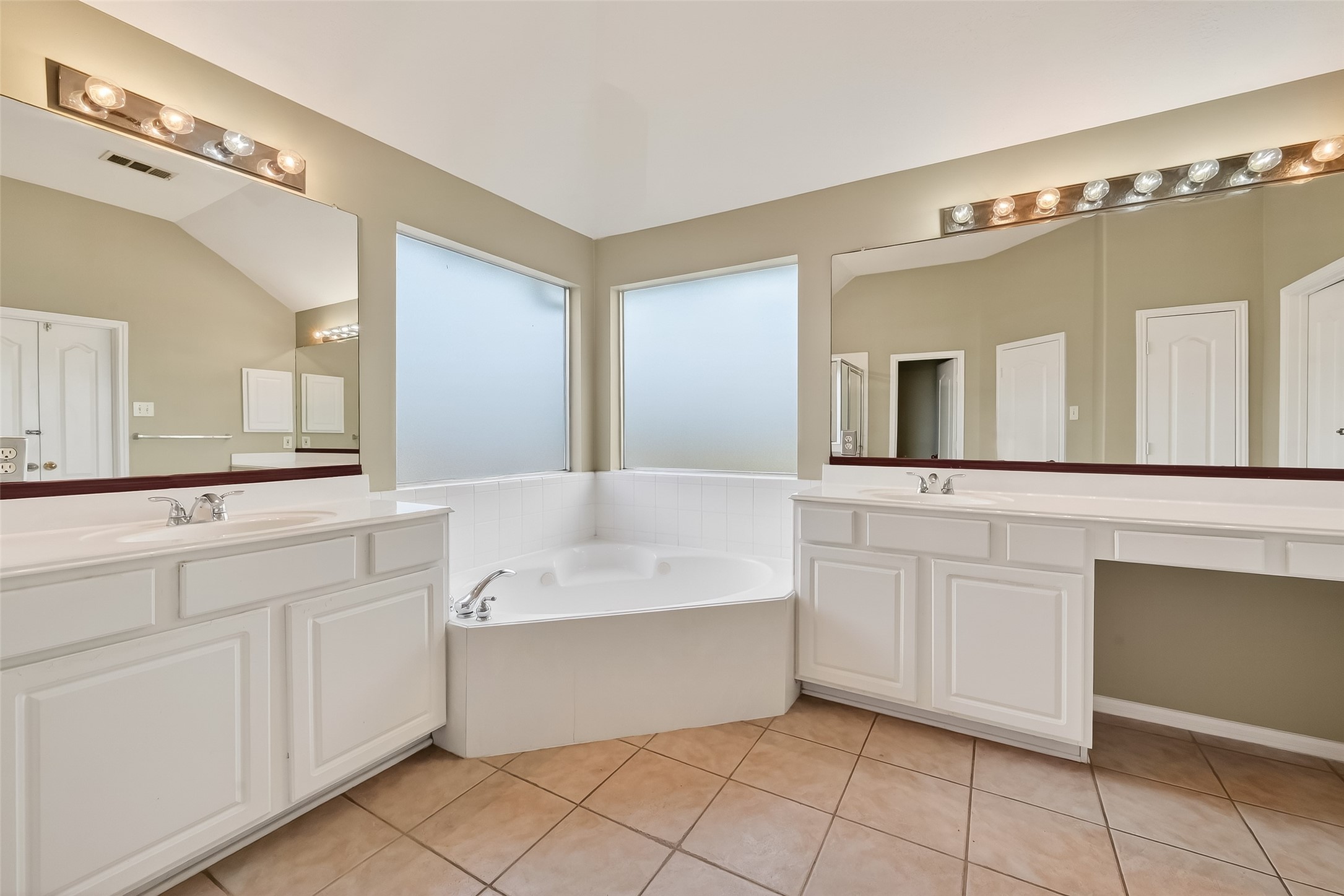 16639 Village View Trail Sugar Land, TX 77498 - Photo 38 of 50 a spacious bathroom with a double vanity sink mirror and bathtub
