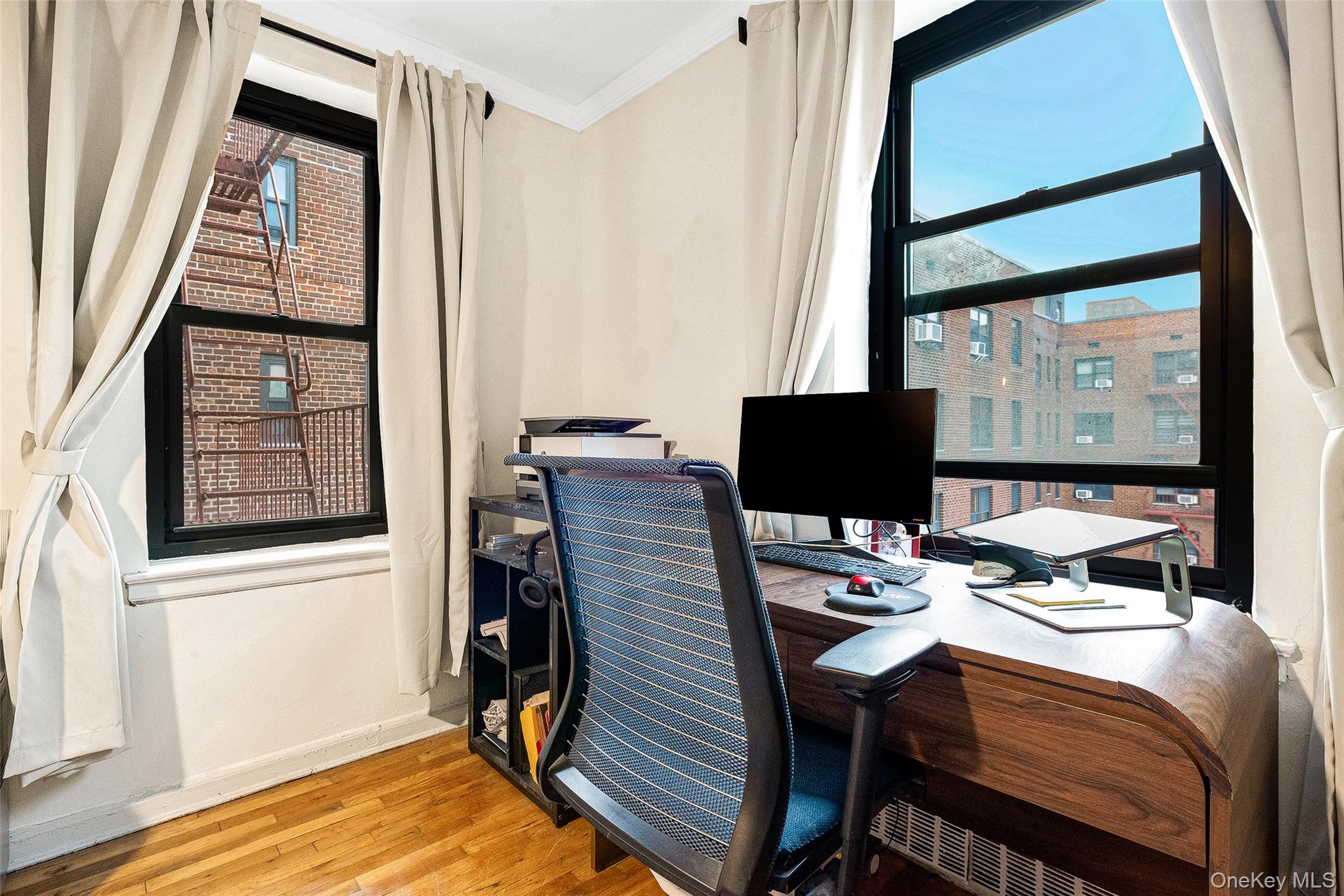 100-11 67th Road, Unit 508 Queens, NY 11375 - Photo 21 of 24 a view of a workspace with furniture and a window